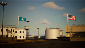 Oil storage tanks with American and state flags in the background