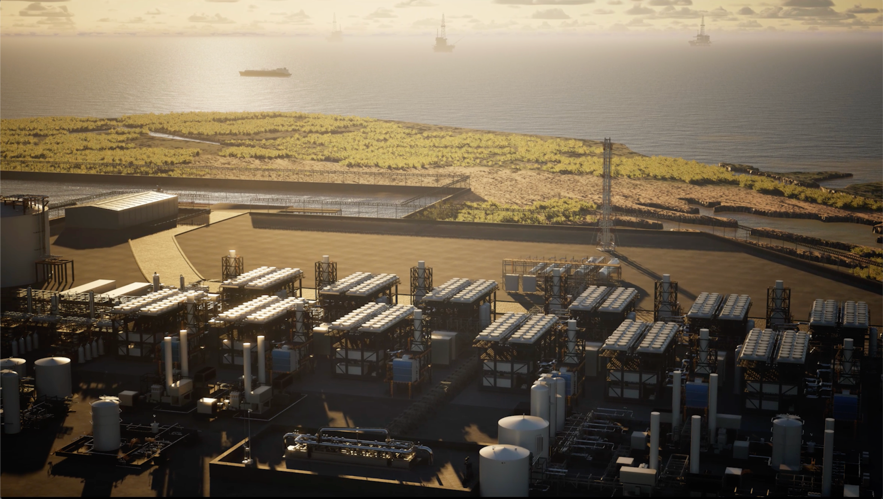 Industrial area with storage containers near a body of water during sunset.